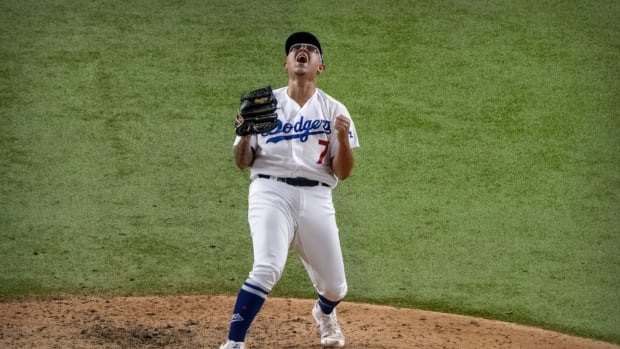 Oct 27, 2020; Arlington, Texas, USA; Los Angeles Dodgers relief pitcher Julio Urias (7) celebrates defeating the Tampa Bay Rays in game six of the 2020 World Series at Globe Life Field. Mandatory Credit: Jerome Miron-USA TODAY Sports